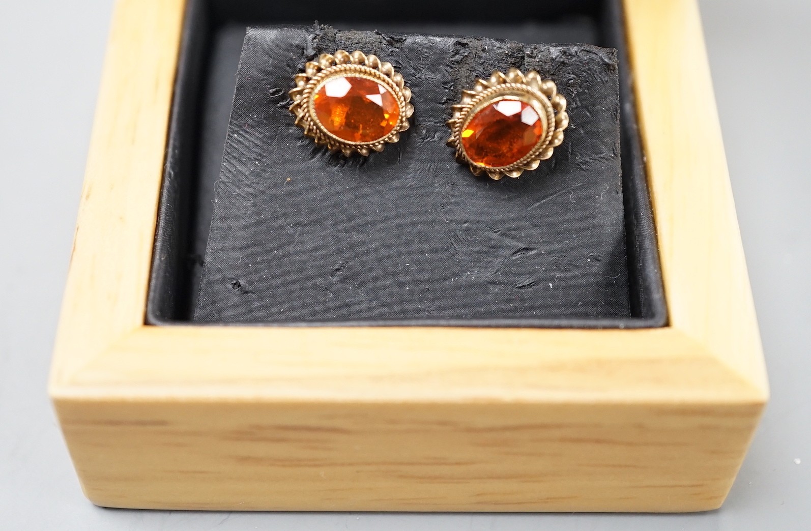 A modern pair of 9ct gold and fire opal set oval earrings, 11mm, gross weight 1.8 grams.